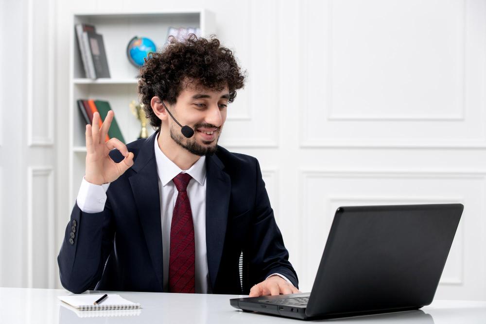 customer-service-handsome-young-guy-office-suit-with-laptop-headset-showing-ok-gesture macbook